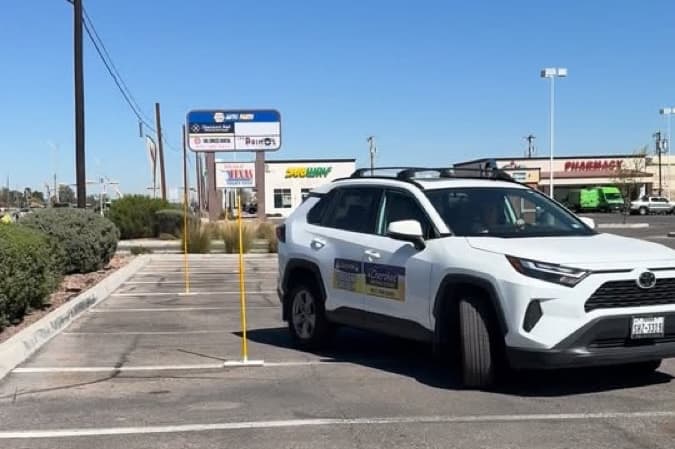 Cherokee Driving School vehicle practicing parking in an El Paso parking lot